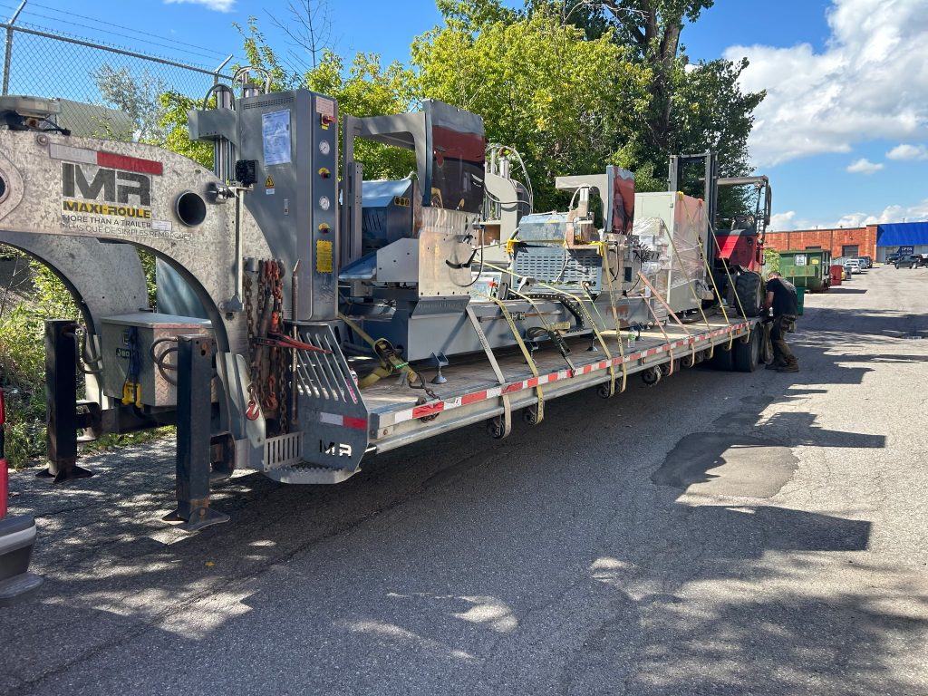 Industrial machinery secured on a Transport JKM trailer.