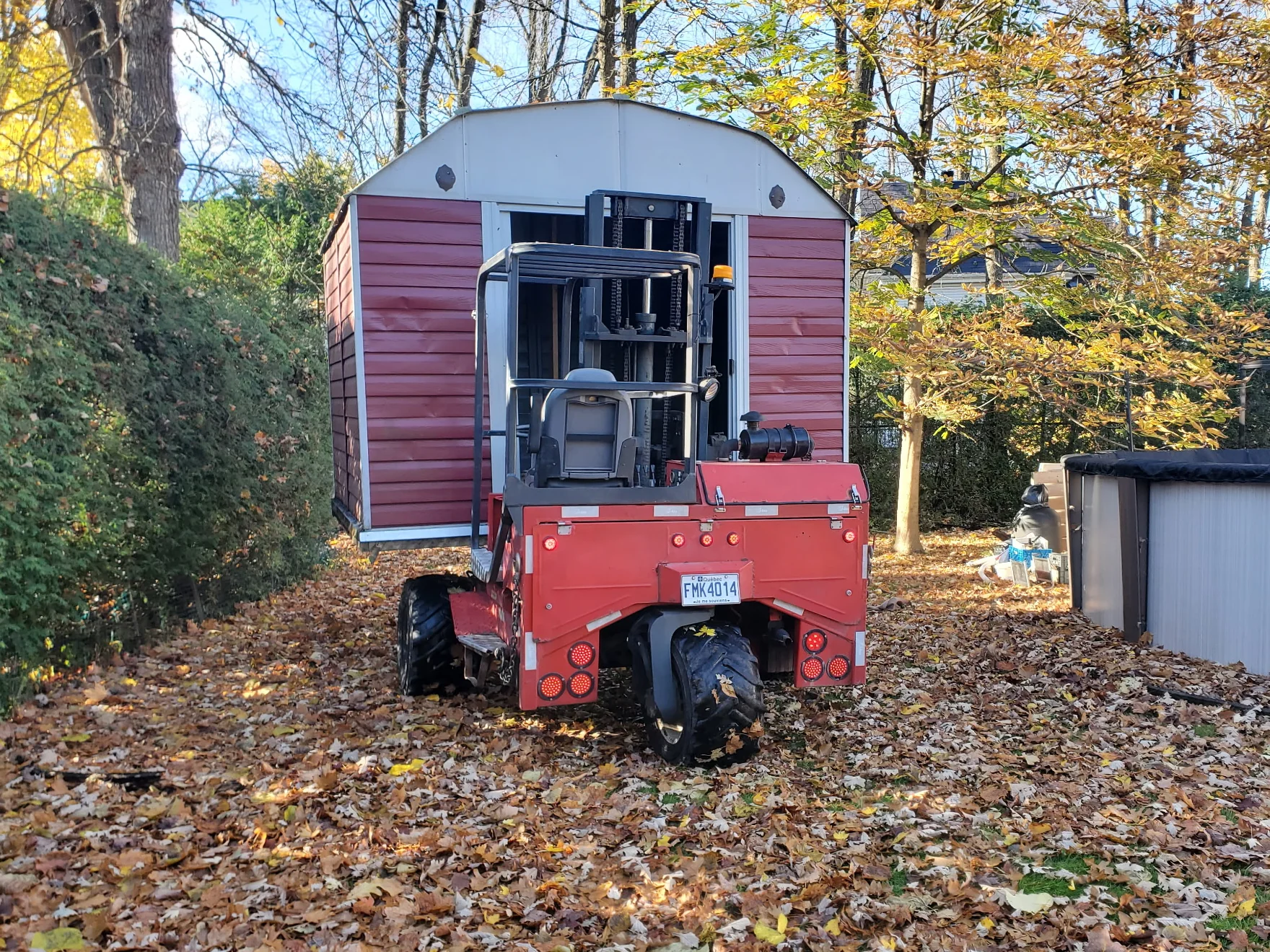A red shed being moved.