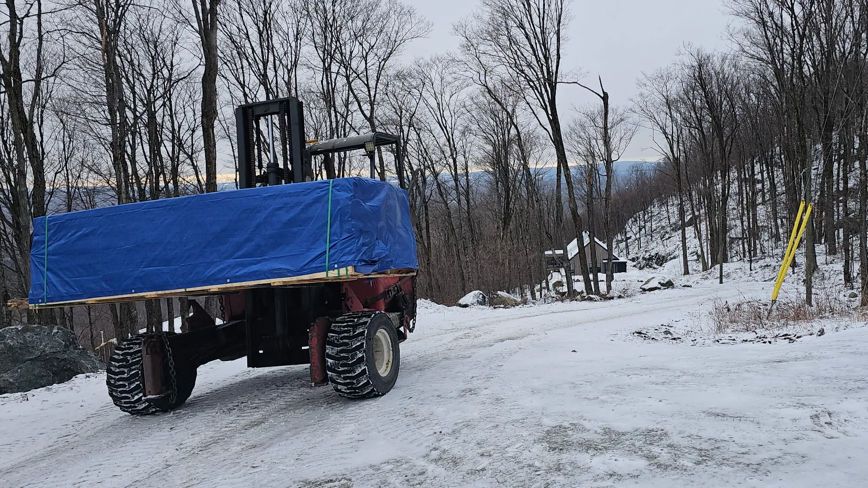 A tarped load on a trailer in winter.